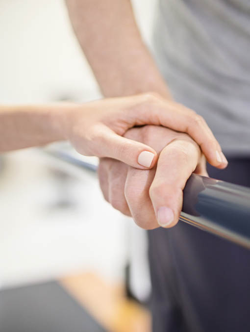 Image of Physical Therapy - Person Using Parallel Bars Image of Physical Therapy - Person Using Parallel Bars